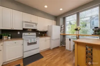 Stunning kitchen with granite counter tops, ample natural light and roll around island. You can use the build in counter space as a breakfast bar, coffee bar, work space or baking station.    All appliances convey with property.