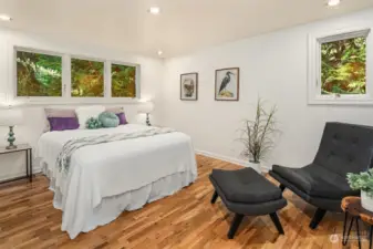 Second main floor bedroom; hardwood floors and windows on two sides. Bright and cheerful.