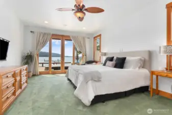 Main floor primary bedroom opens up to the hot tub/deck