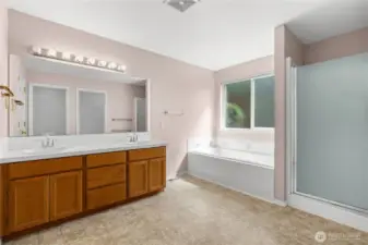 Primary 5-Piece En Suite Bath with extra long tiled vanity, soaking tub and separate shower.