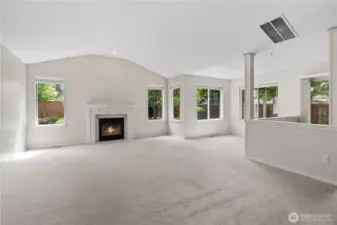 Great Room with Vaulted Ceilings and Gas Fireplace. Sitting Room to the right is great as WFH space.