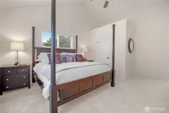 The primary suite is large, has vaulted ceilings, a WIC and a ceiling fan.