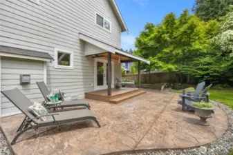 A beautiful stamped concrete deck is a showpiece in the backyard.