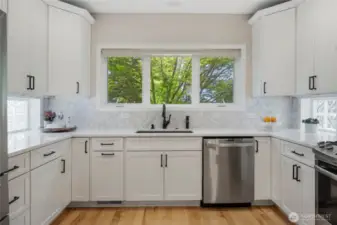 The updated kitchen is the heart of the home - beautiful, bright cabinets and lots of storage.
