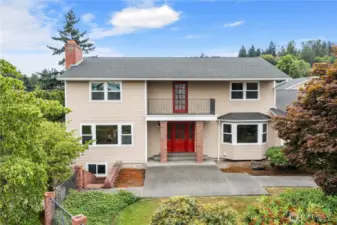 Straight on view of home with large sidewalk leading to striking front door!