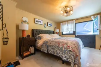 Large bedroom upstairs with private balcony to enjoy your morning coffee, overlooking the serene back yard. Can comfortable fit king size bed as pictured.