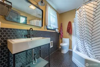 Bath on main level off of the breakfast nook. There is a pocket door across from the sink from the mudroom.
