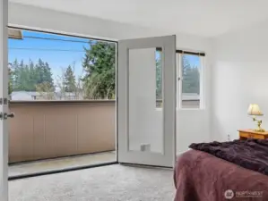 Primary bedroom with French doors opening to balcony
