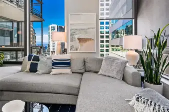 Walls of windows allow great natural light and peekaboo views of downtown and the waterfront from inside the condo.