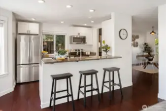 Kitchen with new appliances and bar seating