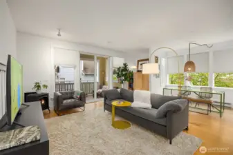 Tall ceilings and windows allow for plenty of natural light. View to the living room, dining room, built-in maple cabinet and slider to the covered balcony.