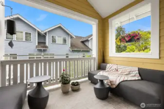 The balcony is protected by a vaulted bead bead board ceiling and has east and west views.