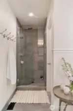 Premium Hansgrohe fixtures enhance the sophistication of the shower area.