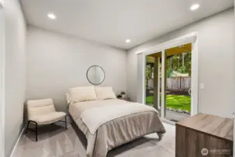 Downstairs guest bedroom with private outdoor seating area.