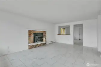 Wonderful living room with tiled flooring and fireplace insert, with pass through to dining room.