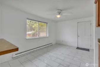 From entrance into Dining Room, pass through on left, Kitchen on right, ceiling fan and garage access.