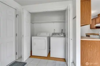 Washer and Dryer in Dining area next to garage and kitchen.