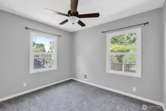 Main floor Primary bedroom with ceiling fan
