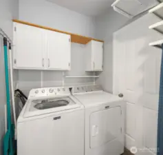 Laundry room with cabinets and storage shelves not shown in photo.