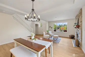Cute dining room open to living room looking out to the West through the window.