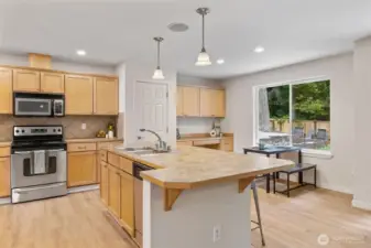 Kitchen eating area with a built in nook and a wonderful window view of the backyard.