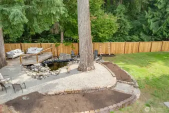 Drone view of the Deck and waterfall feature. Plenty of seating for entertaining, along with an area to plant flowers, shrubs, whatever you would like to personalize it!