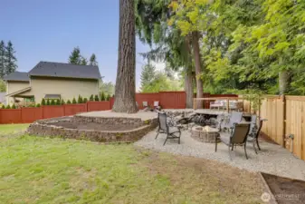 Daytime picture of the firepit area, enjoying the waterfeature and private peaceful backyard.