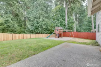 From the large patio overlooking the fully fence backyard along with the playset that will stay with Buyer!