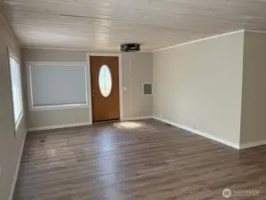 Main entrance to living room. Room darkening honeycomb shades on west side of home.