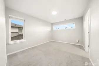 Bedroom 3 with walk in closet and a custom closet organizer