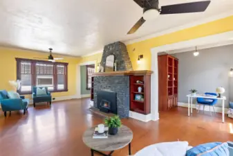 Clinker brick fireplace in living room with view of the den