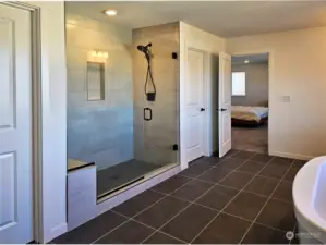 The primary bathroom has a large shower and two walk-in closets.