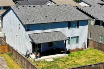 Back of the house showing the covered patio area and fenced back yard.