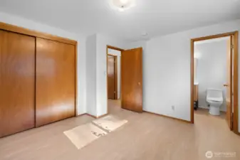 Another view of the Primary Bedroom showing the double door closet and private bathroom.