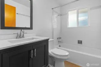 Full guest bathroom with shower/tub combo.