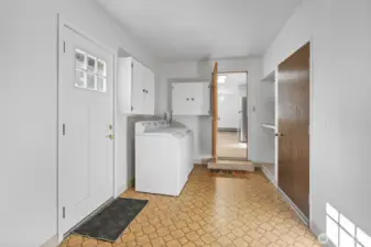 Spacious laundry room with plenty of storage space. Washer and dryer stay. Brown door leads to two car attached garage.