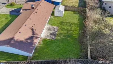 Fully fenced back yard with patio.