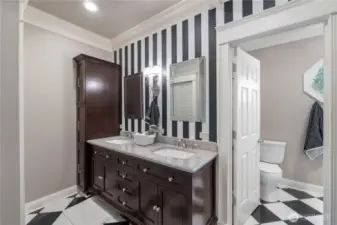 Updated primary bath featuring walk in closet and storage cabinets