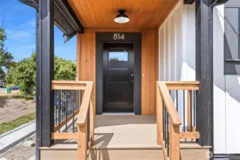 New front porch includes new roof trusses, wood features and wood look APEX PVC decking.