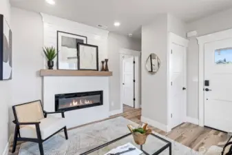 View from the living room showing the entry closet, fireplace & Primary Bedroom entry.