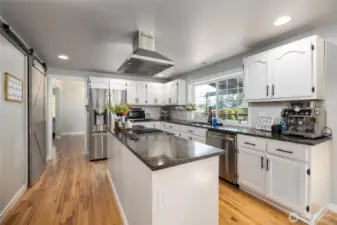 The chef's kitchen has an abundance of quartz countertops and a walk in pantry.