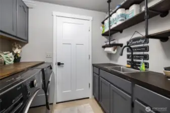 The utility is off the 3 car garage with lots of storage space, counters and a utility sink.