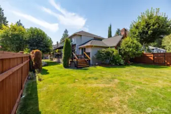 There is a lot of yard that is fenced along the side of the house.