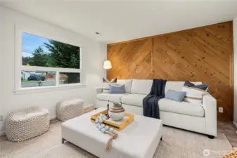 Living room features large window that overlooks the front yard and lets in lots of natural light.