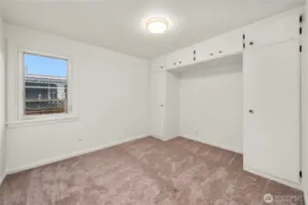 First bedroom features built in cupboards/wardrobe.
