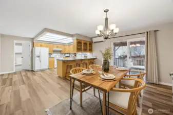 Dining area with sliding doors to covered back deck with ramp.