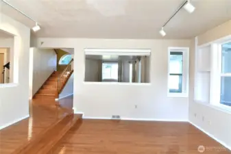 family room with hardwood floors and staircase access to second floor bedrooms area
