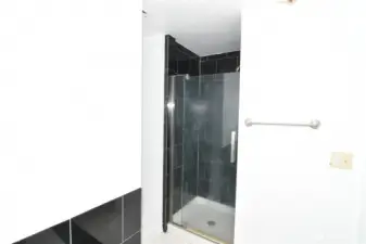 walk-in shower with tile surround