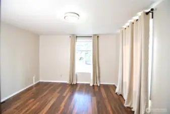 bright second bedroom with two window overlooking the backyard and side yard