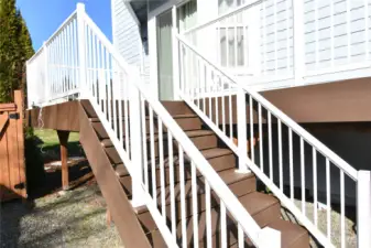 exterior stair leading to composite deck and side yard